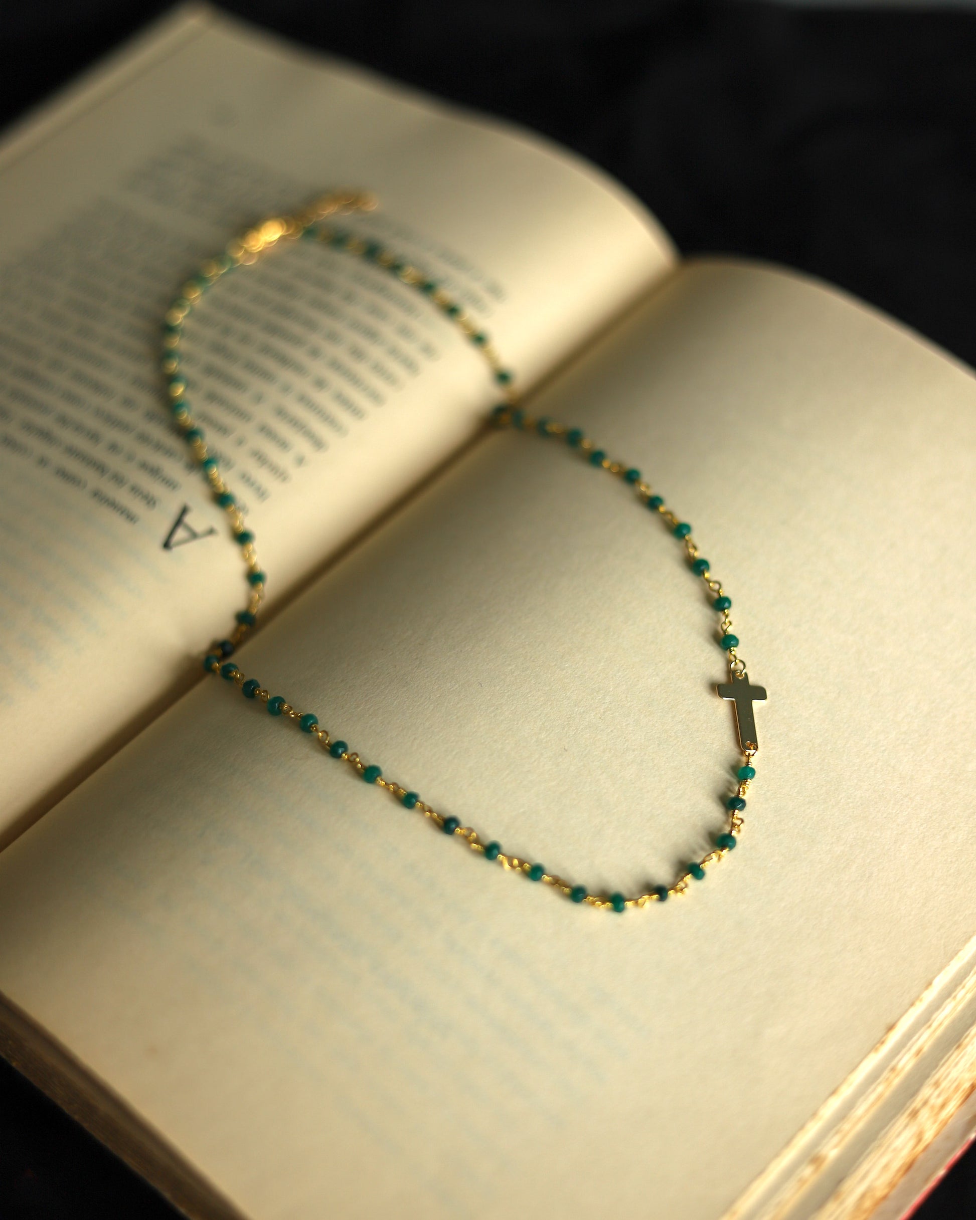 Verona Cruz necklace on the side